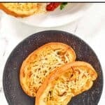 Slices of homemade Marie Callender's cheesy garlic toast on a plate.