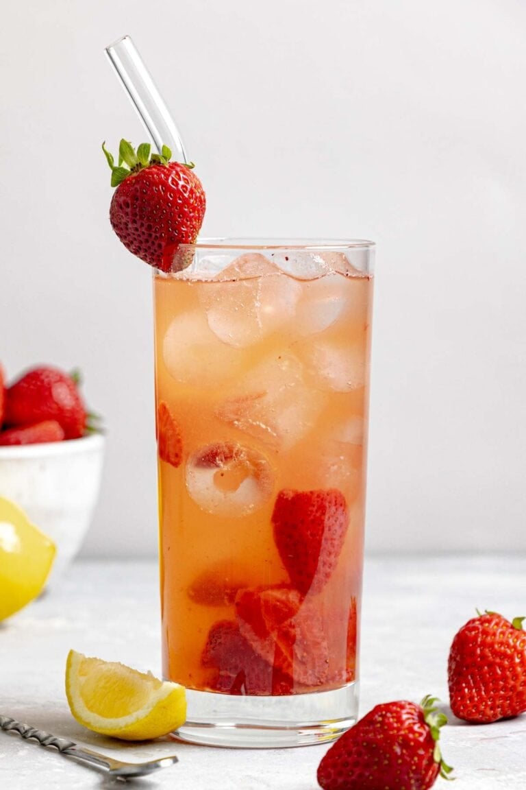 Copycat Red Robin freckled lemonade, strawberries, and lemon wedge.