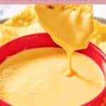 Homemade Taco Bell nacho cheese and a tortilla chip dipped in the sauce.