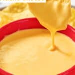 Dipping a tortilla chip in homemade Taco Bell nacho cheese sauce.