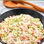 Homemade Golden Corral seafood salad in a large bowl and salad tongs behind it.