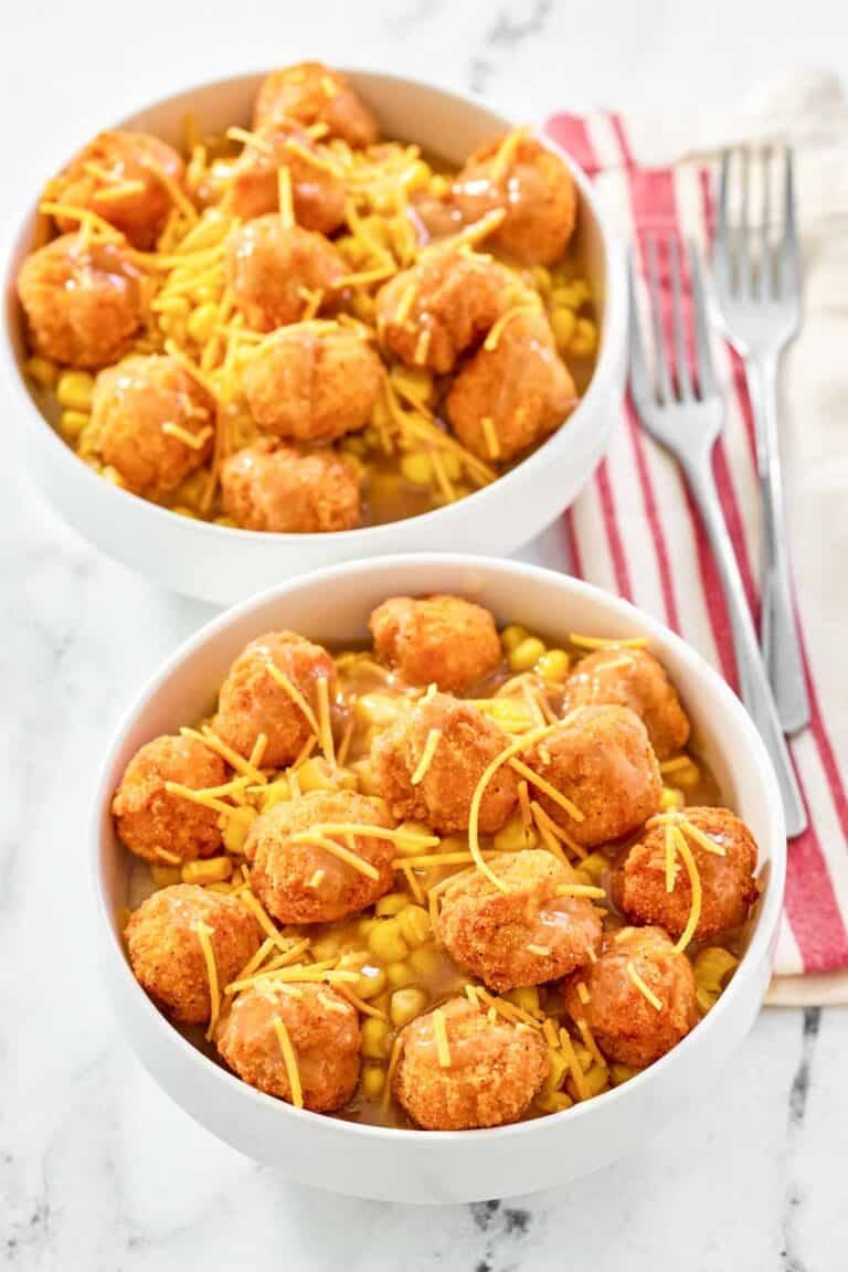 Two copycat KFC famous bowls and two forks on napkins.