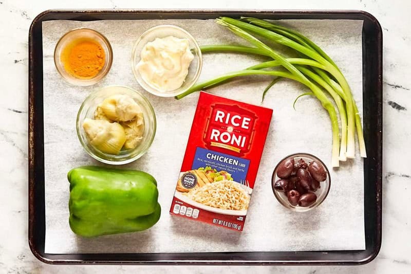 Rice-A-Roni artichoke salad with curry ingredients on a tray.
