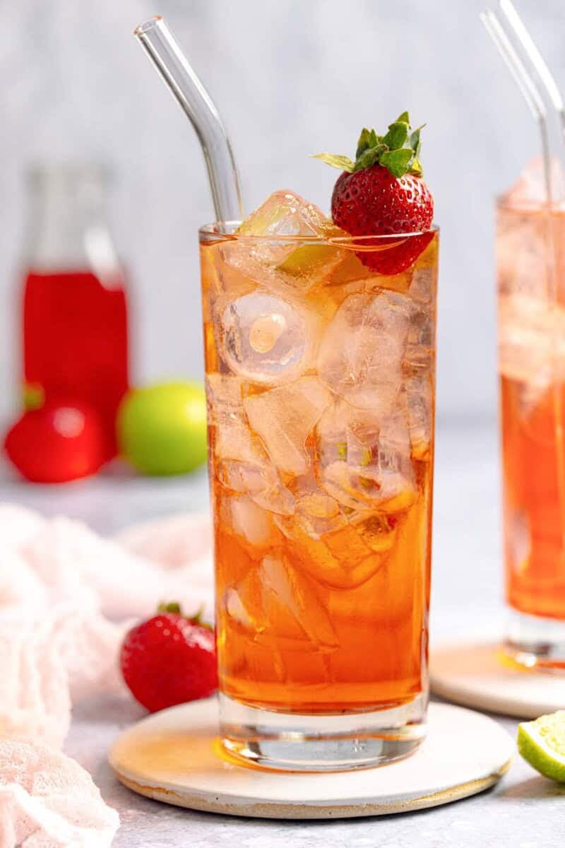Copycat Sonic strawberry limeade in a tall glass on a coaster.