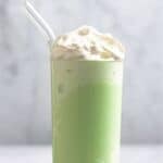 A homemade starbucks matcha frappuccino in a tall glass.