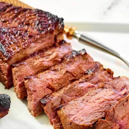 Steak made with copycat steak and ale kensington club marinade on a platter.