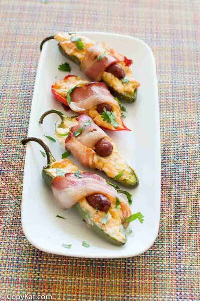Bacon wrapped little smokie poppers on a platter.
