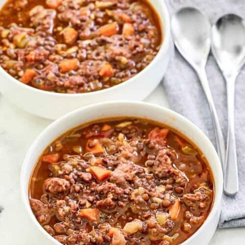 Copycat Carrabba's sausage lentil soup in two bowls.