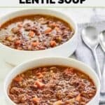 Homemade Carrabba's sausage lentil soup in two bowls and two spoons by them.