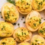 Smoked deviled eggs scattered on a platter.