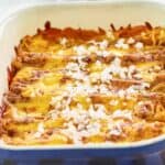 Homemade El Chico cheese enchiladas topped with chopped onions in a baking dish.