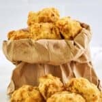 Homemade Fat Ronnie's deep fried mushrooms in a paper bag and in front of it.