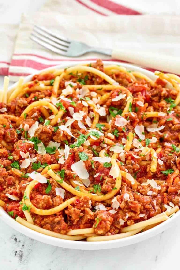 A bowl of copycat Olive Garden spicy three meat sauce with bucatini.