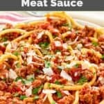 Homemade Olive Garden spicy three meat sauce with bucatini garnished with parmesan and parsley.