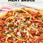 A bowl of Olive Garden spicy three meat sauce with bucatini garnished with parsley.