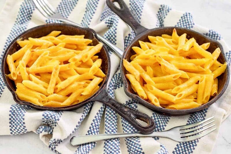Copycat Outback Steakhouse mac and cheese servings in small cast iron skillets.