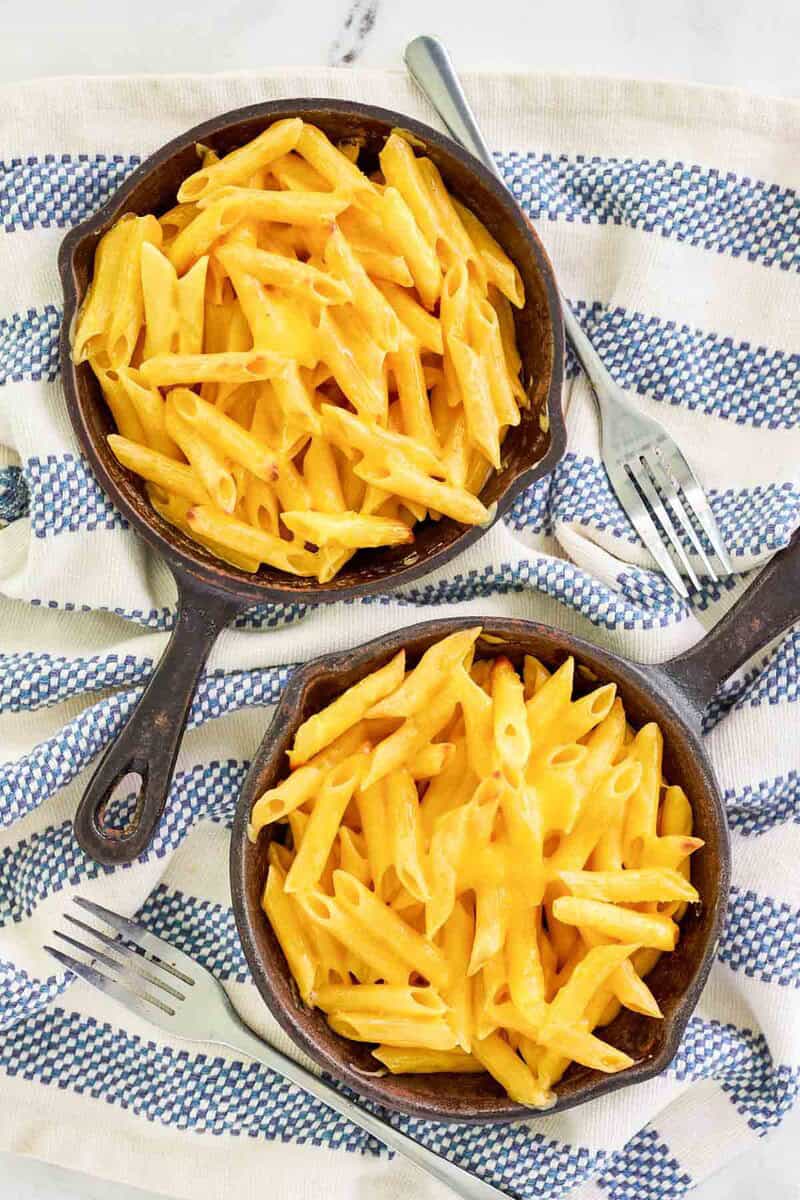 Copycat Outback Steakhouse mac and cheese in two small cast iron skillets.