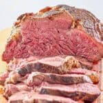 An oven roasted beef tenderloin roast on a cutting board.