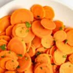 Buttery boiled carrots on a plate.