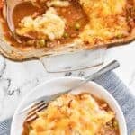 Homemade Cheesecake Factory shepherd's pie in a glass baking dish and a serving on a plate.