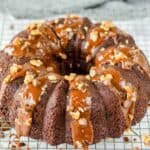Homemade triple chocolate bundt cake on a wire rack.