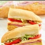 Homemade Kmart sub sandwich cut in half and one wrapped in plastic wrap.