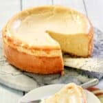 Copycat Lindy's New York cheesecake and a slice on a plate in front of it.