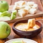 Homemade Melting Pot cheddar cheese fondue served with apple and bread slices.