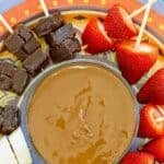 Copycat Melting Pot chocolate fondue served with fudge, strawberries, and banana slices.