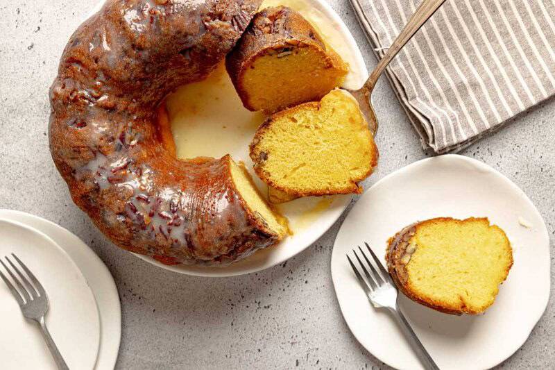 Ms. Bessie's New Orleans rum cake with hot butter rum glaze on a platter and a slice on a plate.
