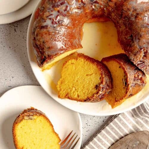 Ms. Bessie's New Orleans rum cake with butter rum glaze on a platter and a slice on a plate.