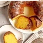 Homemade Ms. Bessie's New Orleans rum cake on a platter and a slice on a plate.