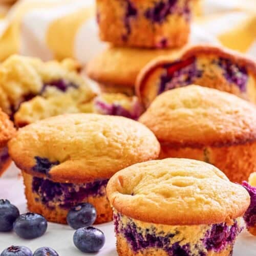 Copycat Otis Spunkmeyer blueberry muffins and fresh blueberries by them.