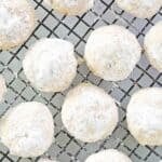 Homemade pecan sandies cookies on a wire cooling rack.
