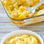 Yellow squash casserole with Ritz crackers in a baking dish and a bowl.