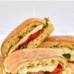 Homemade Starbucks tomato and mozzarella on focaccia sandwiches on a wooden board.