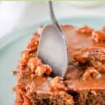 A slice of homemade Texas sheet cake with a spoon in it.