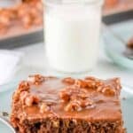 A slice of homemade Texas sheet cake and a spoon on a plate.