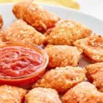 A plate of homemade Totino's pepperoni pizza rolls and marinara.