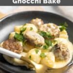 Creamy alfredo sausage and gnocchi bake on a plate and a fork on the edge of the plate.