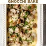 Creamy alfredo sausage and gnocchi bake in a ceramic baking dish.