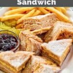 Homemade Bennigan's monte cristo sandwich, raspberry jam, fries, and pickle slices.