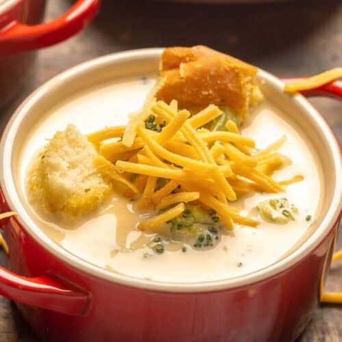 Copycat Black-eyed Pea broccoli cheese soup topped with shredded cheese and croutons.