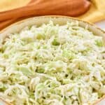 Homemade Brookville Hotel coleslaw and wooden salad servers behind it.