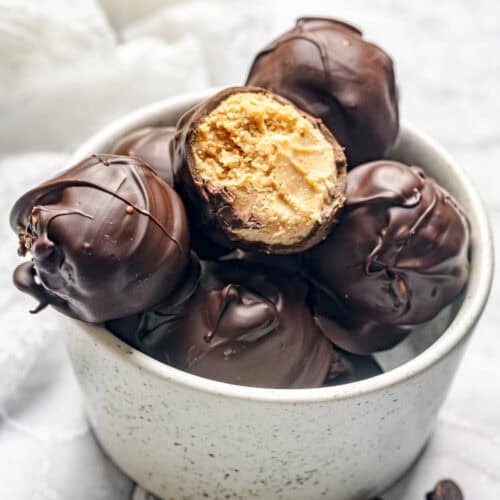 Homemade chocolate peanut butter balls in a bowl.