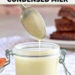 Homemade sweetened condensed milk on a spoon and in a glass jar.