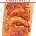 Slices of homemade North Woods Inn garlic cheese bread on a serving board.