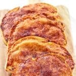 Slices of homemade North Woods Inn garlic cheese bread on a wood board.