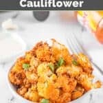 A bowl of air fryer buffalo cauliflower on a marble surface.