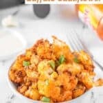 A bowl of air fryer buffalo cauliflower garnished with green onions.